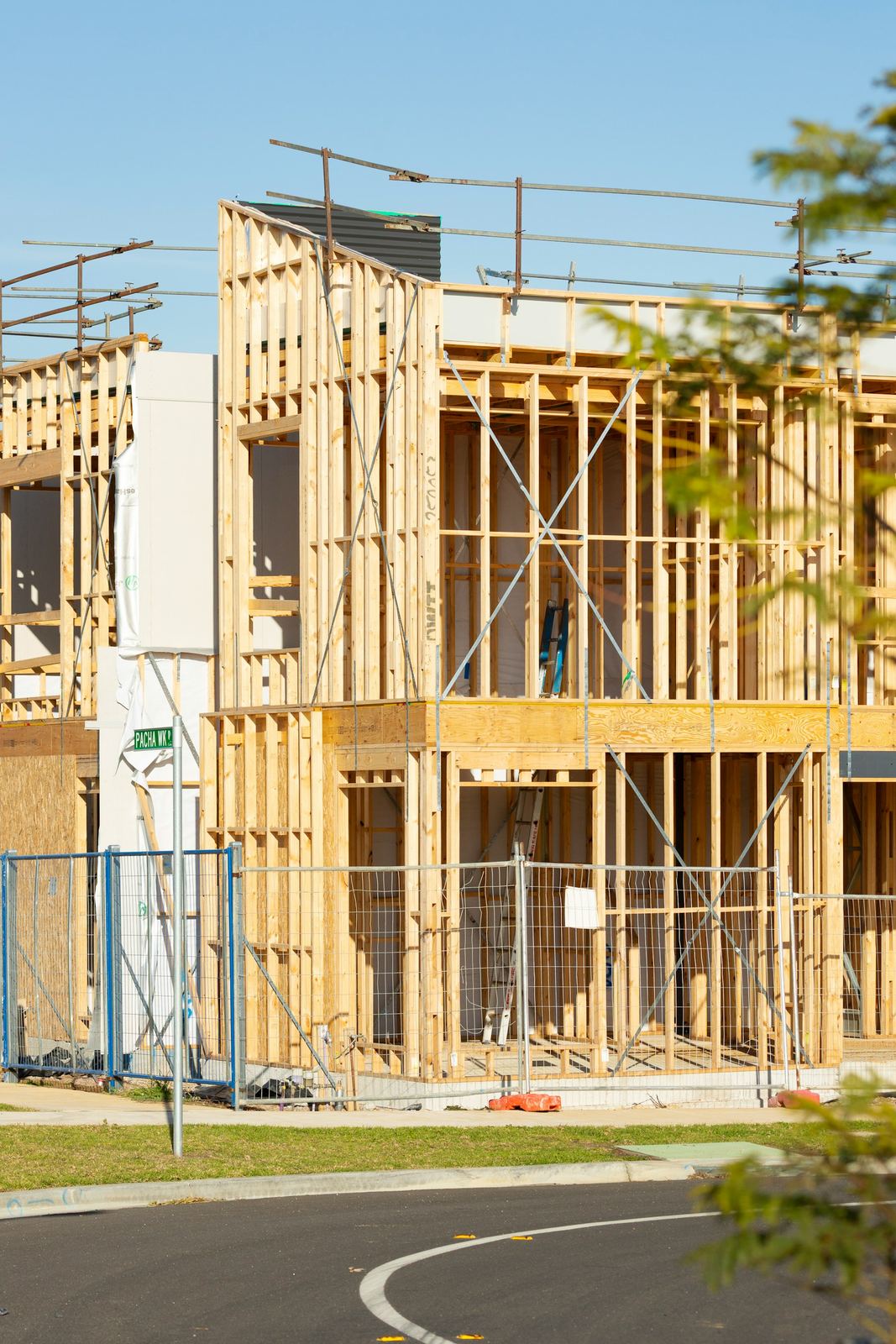 Two-story addition framing against a blue sky
