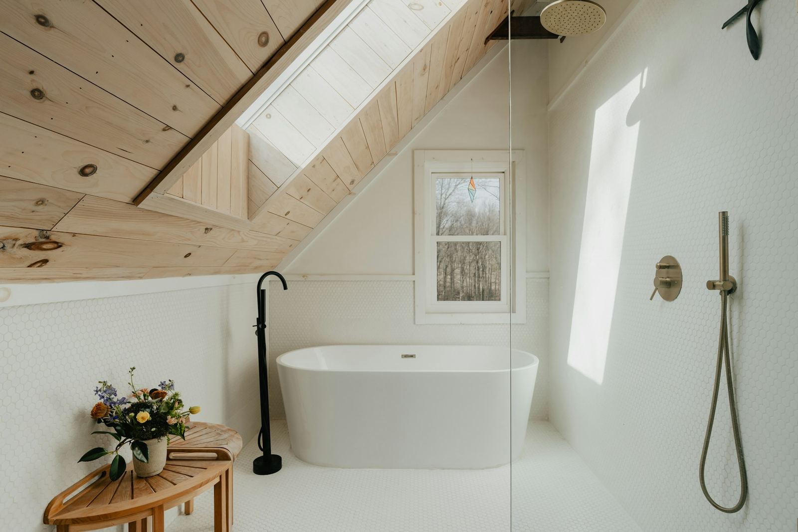 Attic bathroom with pine ceiling and freestanding tub